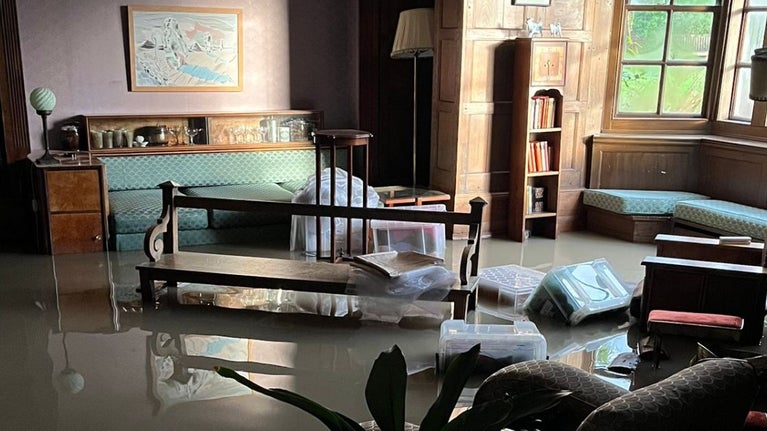 An image showing furniture submerged in floodwater in the Keiller Parlour inside Avebury Manor.